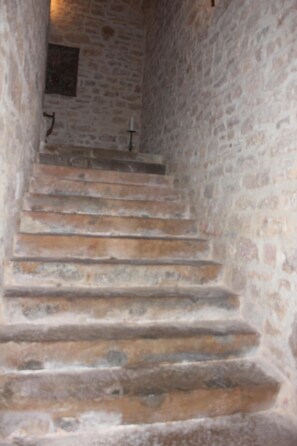 A stone staircase leading upwards in a building. -  Private castle in France with pool sleep 20 (Saint-Medard-de-Presque)