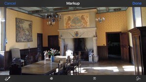 A room with a fireplace, a large painting on the wall, and a chandelier. -  Private castle in France with pool sleep 20 (Saint-Medard-de-Presque)