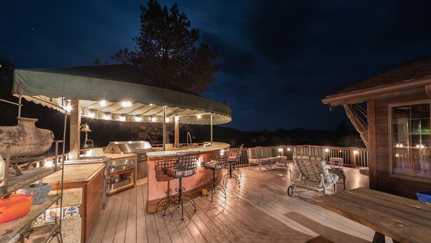 An outdoor bar area with a covered seating area, a grill, and a wooden deck. - Private Pickleball Ct - Indoor Hot Tub - Spa Room - Lift Tkts  (Windham)