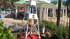 A lifeguard tower with a red base, white structure, and green roof. - UNIT # 7 Ocean and Downtown view LAUDERDALE BY THE SEA  200+- steps to beach fun (Lauderdale-by-the-Sea)