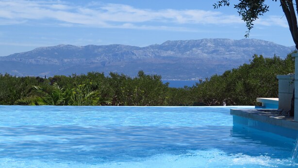 A swimming pool with a mountain view in the background.