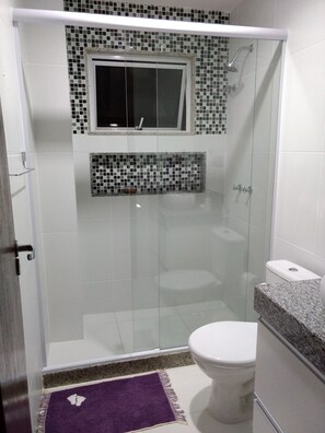 Shower, hair dryer, towels, toilet paper