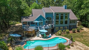 A large house with a swimming pool, a covered patio, and a fenced deck area. - Waterfront Retreat w/ Pool, Hot Tub, Dock & Sand Beach. Relax & enjoy the Rivah! (Lancaster)