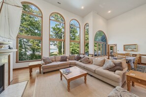 A spacious living room with a large sectional sofa, a wooden coffee table, and a fireplace. - Waterfront Retreat w/ Pool, Hot Tub, Dock & Sand Beach. Relax & enjoy the Rivah! (Lancaster)