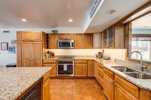 Enjoy cooking in this well-equipped kitchen with a microwave, oven, and sink.