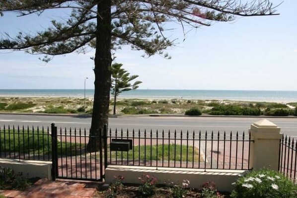A coastal view with a paved walkway, a metal fence, and a mailbox. - Esplanade Beach House with beautiful sea views (Semaphore)