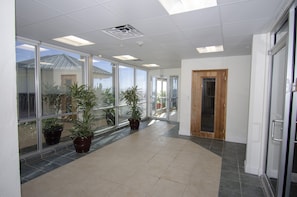Stroll through this beautifully designed corridor, lined with lush greenery and natural light.