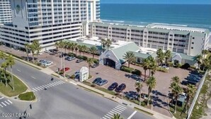 A hotel with multiple floors, a parking lot, and a view of the ocean. - Daytona Beach 12th Floor Oceanview With Spectacular Views (Daytona Beach)