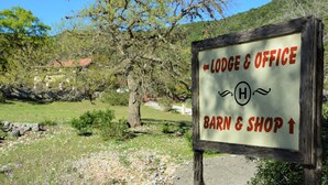 A sign indicating directions to the lodge, office, barn, and shop. - SPECTACULAR LODGE ON PRIVATE RANCH. PERFECT FOR SMALL AND LARGE GATHERINGS! (LEAKEY)