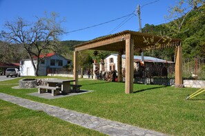 A gazebo with a stone bench and picnic table, surrounded by a stone pathway. - SPECTACULAR LODGE ON PRIVATE RANCH. PERFECT FOR SMALL AND LARGE GATHERINGS! (LEAKEY)