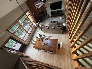 A spacious living area with a large wooden dining table, a fireplace, and a television. - A Breath of Fresh Air—Weekend Plans at the Timberview (Carroll)