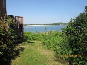 Enjoy a serene lakeside view from the deck, perfect for a relaxing boat ride.