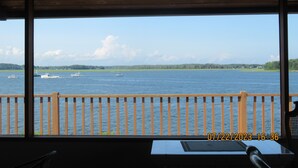 A view from a room with a wooden balcony overlooking a body of water with several boats. - The Waterfront Deckhouse-Pine Point Beach Waterfront Property (Scarborough)