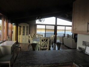 Enjoy meals in the kitchen with a large island and dining area overlooking a body of water.