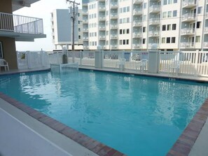 Enjoy a refreshing swim in the pool surrounded by a balcony with a view.