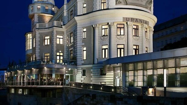 Un bâtiment historique doté d’un dôme imposant et portant l’inscription « URANIA » sur sa façade.