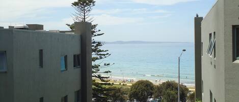 A view of a beach with buildings in the foreground.
