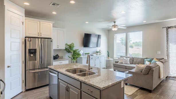 A modern kitchen with a stainless steel refrigerator, double sink, and granite countertops. - Bright Modern 3BR & Loft - Snow Canyon View w/ Deck (St. George)