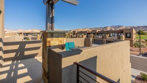 A modern outdoor seating area with a view of a desert landscape. - Bright Modern 3BR & Loft - Snow Canyon View w/ Deck (St. George)