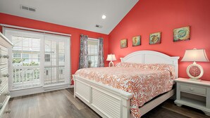 A bedroom with a white bed, a nightstand, a dresser, and a window with blinds. - 12th St / bayside - 4 br multi level townhouse. Nicely furnished and well cared for. (Ocean City)