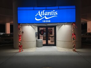 The exterior of a building with a sign reading "Atlantis 10300".