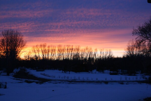 A snowy landscape with a sunset.