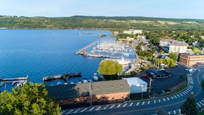 Stunning marina views with sailboats and motorboats docked, surrounded by residential and commercial buildings.