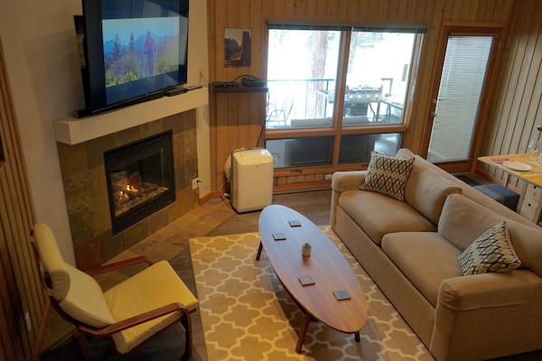Living room features large flat screen TV and gas fireplace