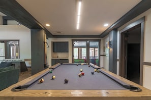 A pool table with balls, a sofa, and a view of the outside. - Luxury Remodeled 2BR/3BA River Run • Vaulted Ceilings • Washer/Dryer • Sleeps 8 (Keystone)