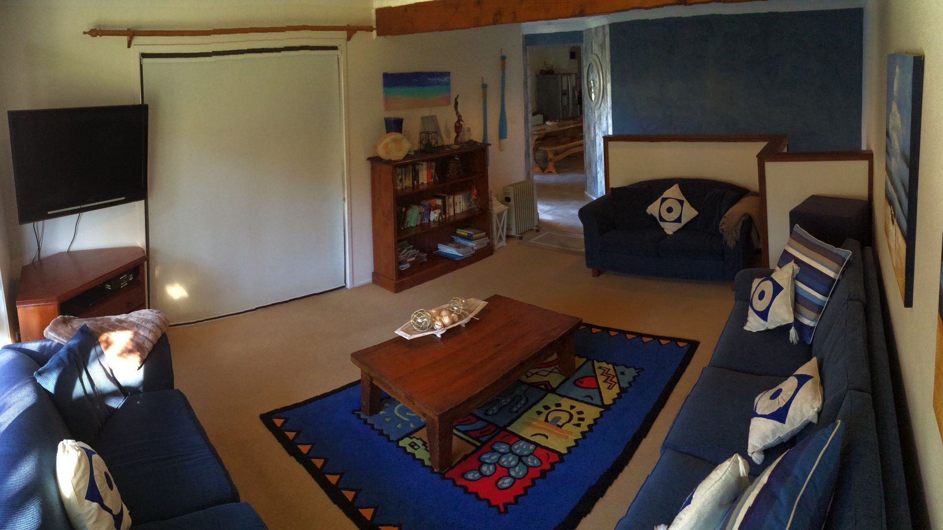 Una sala de estar con un sofá, una mesa de centro y una estantería.