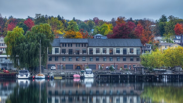 A waterfront building with a dock and boats.