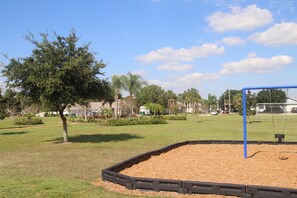 Enjoy a peaceful retreat in a lush park setting with a playground and shaded trees.