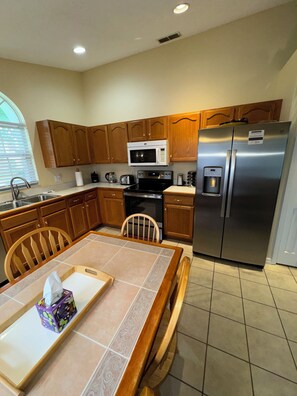 Enjoy cooking in this well-equipped kitchen with a stove, microwave, and refrigerator.