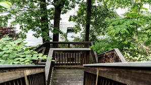 A wooden staircase leading to a dock with a view of the water.