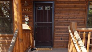 A wooden cabin with a black door, a welcome sign, and a number '1720' above the door. - Beautiful Bison Ridge Cabin that has it all... (Show Low)