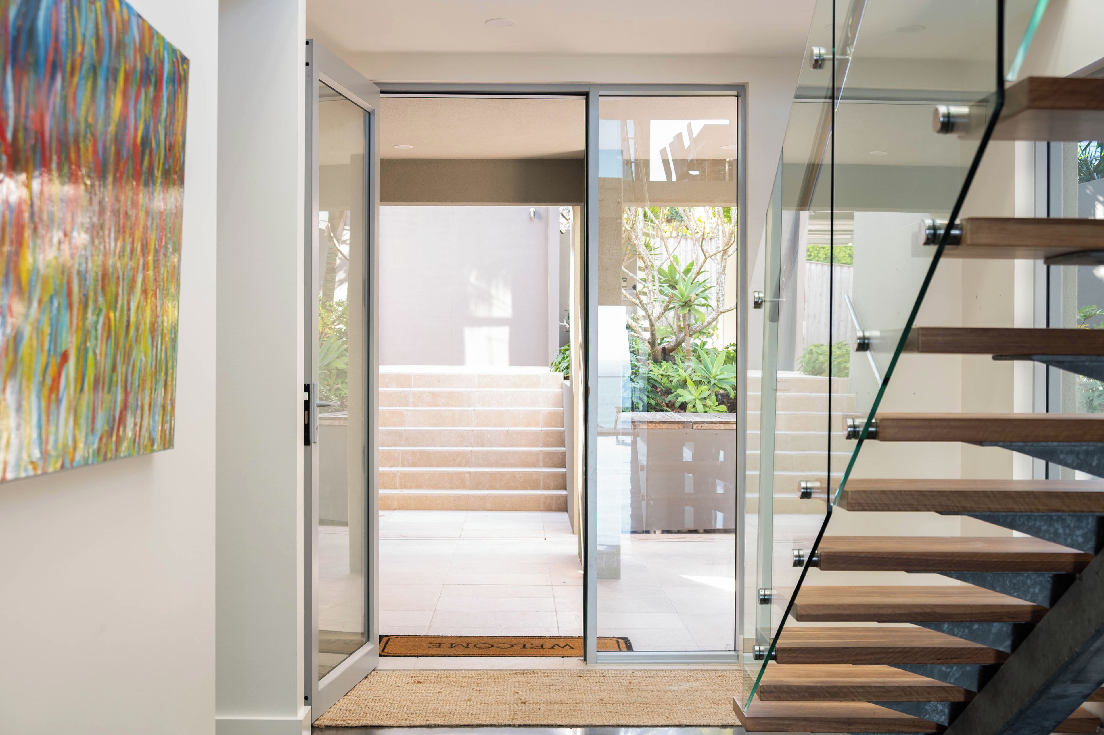 Un intérieur moderne avec une porte vitrée donnant sur un escalier.