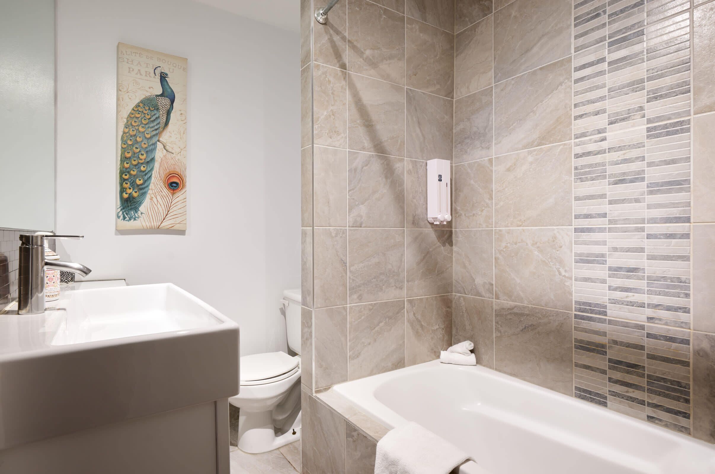 A bathroom with a sink, toilet, and bathtub.