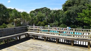 A wooden deck with a pool in the background. - A traditional beach house located near historic downtown Charleston (Isle of Palms)