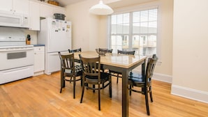 A kitchen with a dining table, chairs, and a window. - Gone Coastal - 2nd Row home; 4BR; Ocean Views from Sun Deck (Surf City)