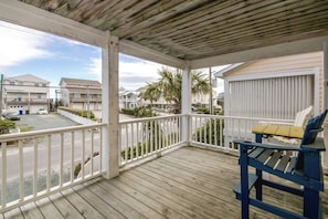 A wooden deck with a railing, a bench, and a view of a residential area with houses and a street. - Gone Coastal - 2nd Row home; 4BR; Ocean Views from Sun Deck (Surf City)