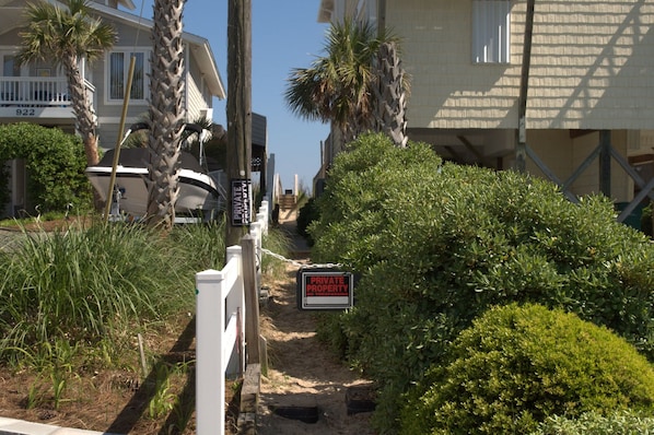 A private property with a gated entrance, a boat, and a well-maintained garden. - Gone Coastal - 2nd Row home; 4BR; Ocean Views from Sun Deck (Surf City)