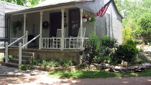 A house with a porch, steps, and an American flag.