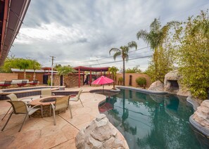 Outdoor pool, a heated pool - Central Oasis-Luxury Furnished Rental w/Waterfall, Grotto, & Outdoor Kitchen (Tucson)
