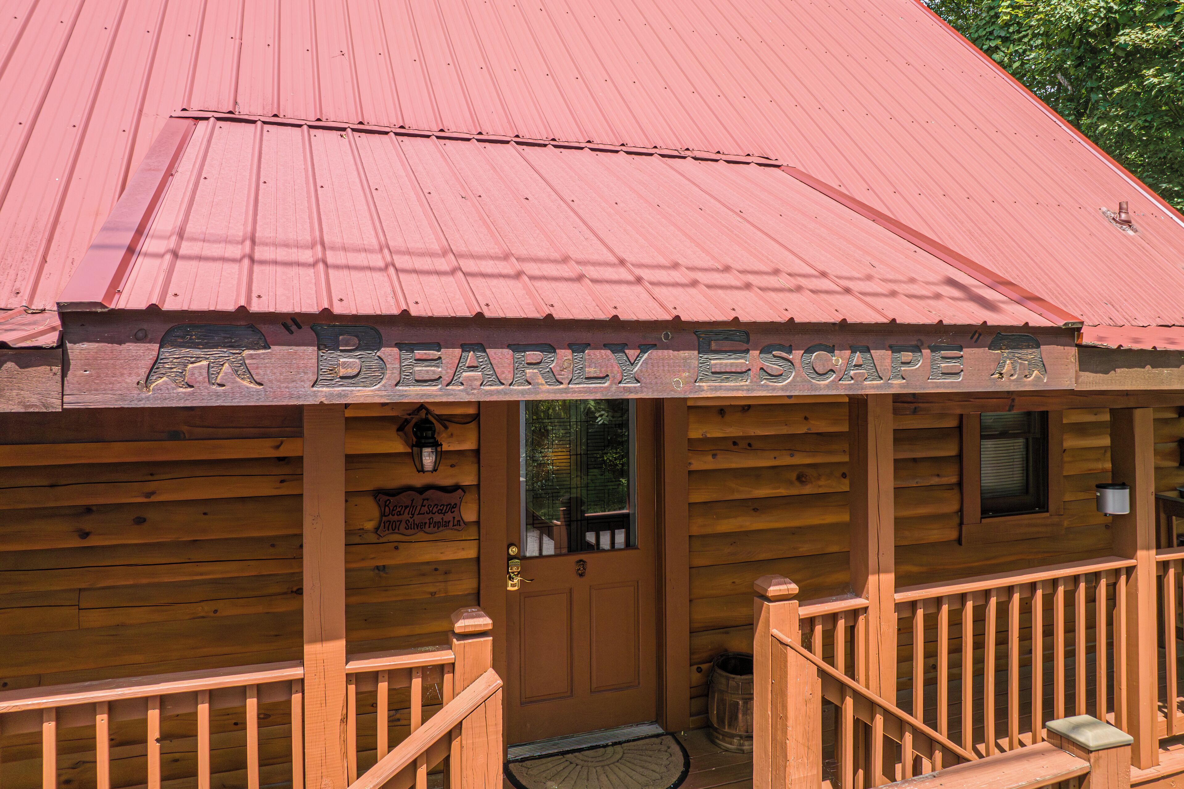 A wooden cabin with a red roof and a sign reading "Bearly Escape".