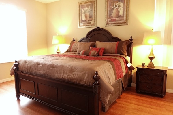 Master King En-suite on Main Floor with king bed, 32' TV, nightstands, dresser and crib