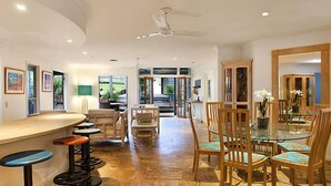 A spacious room with a curved bar, multiple seating areas, and a dining table with chairs. - "Summer Salt" @ Sunshine + Pets & HEATED POOL 150m to the beach! (Noosa Heads)