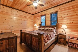 Relax in a cozy space with a large bed, bedside tables, and a dresser.