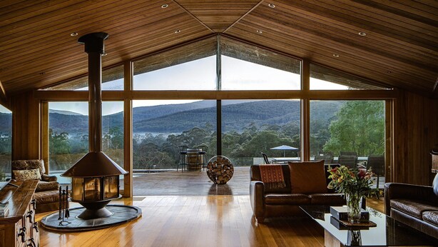 A spacious living area with a large wooden ceiling, a fireplace, and a view of the mountains. - Luxurious Unique, Private Paradise-Kangaroo Manor (Yarra Valley)