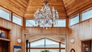 A spacious dining area with a wooden ceiling and large windows offering a view of the outdoors. - Luxurious Unique, Private Paradise-Kangaroo Manor (Yarra Valley)