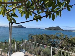 A balcony with a view of the sea and distant islands. - A beach house with colour! (Shoal Bay)